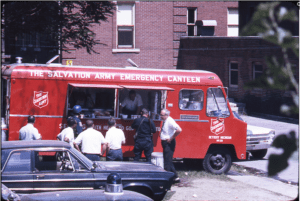 A red Salvation Army canteen truck distributing food to men