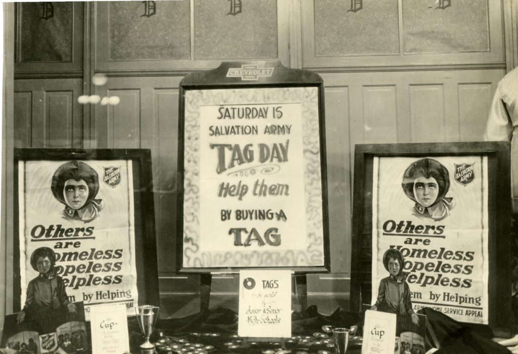 A display of three framed Doughnut Day posters from the 1930s arranged on a table.