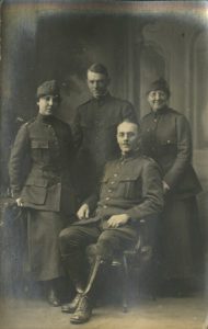 A family group featuring father, mother, son and daughter all wearing Salvation Army WWI uniforms