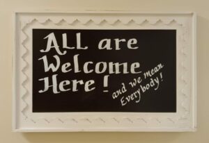 Sign that reads "All are Welcome Here! and We Mean Everybody!"