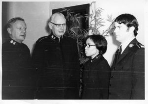 Photograph showing four male Salvation Army officers and Gwendolyn Jones