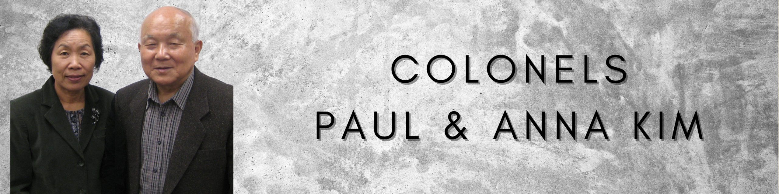 Page title graphic showing Colonels Paul and Anna Kim smiling and wearing street clothes.