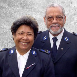 Graphic button showing a photo of Envoys Roberto and Marina Santos