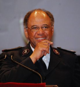 A man wearing a Salvation Army uniform, smiling