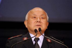 Photo of Colonel Paul Kim standing at a podium