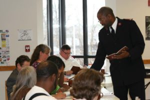 Photograph showing Major K. Kendall Mathews leading a class of adult students.