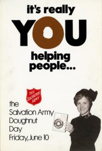 A poster which features a photo of a female Salvation Army officer holding a paper Doughnut Day bank. Text reads: "It's really you helping people ... The Salvation Army Doughnut Day Friday, June 10"