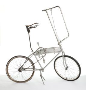 Photograph showing a silver painted bicycle that has been converted into a tall bike