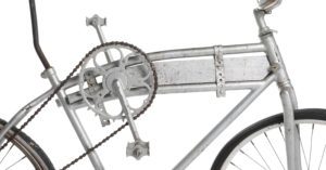 Photograph of the side of a bicycle. The front gears have been strapped in between two top tubes.