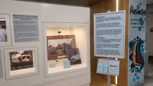 A photo showing the introduction panel in the Perspectives exhibit. The panel text is in English and Spanish and part of an exhibit case can also be seen