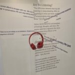 A view of the exhibit Perspectives showing a pair of headphones surrounded by quotes discussing faith and race