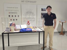 Emmet Burke standing next to the 9/11 display.