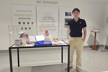 Emmet Burke standing next to the 9/11 display.